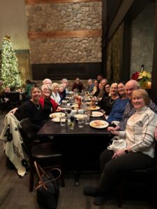Members gathered around a table at the post-concert dinner