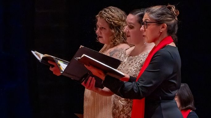 Three soloists performing on stage